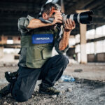 Profissional do Fotojornalismo trabalhando em uma área de guerra