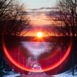 Lens Flare Efeito fotográfico - foto por do sol com reflexo de luz em circulo tons avermelhados